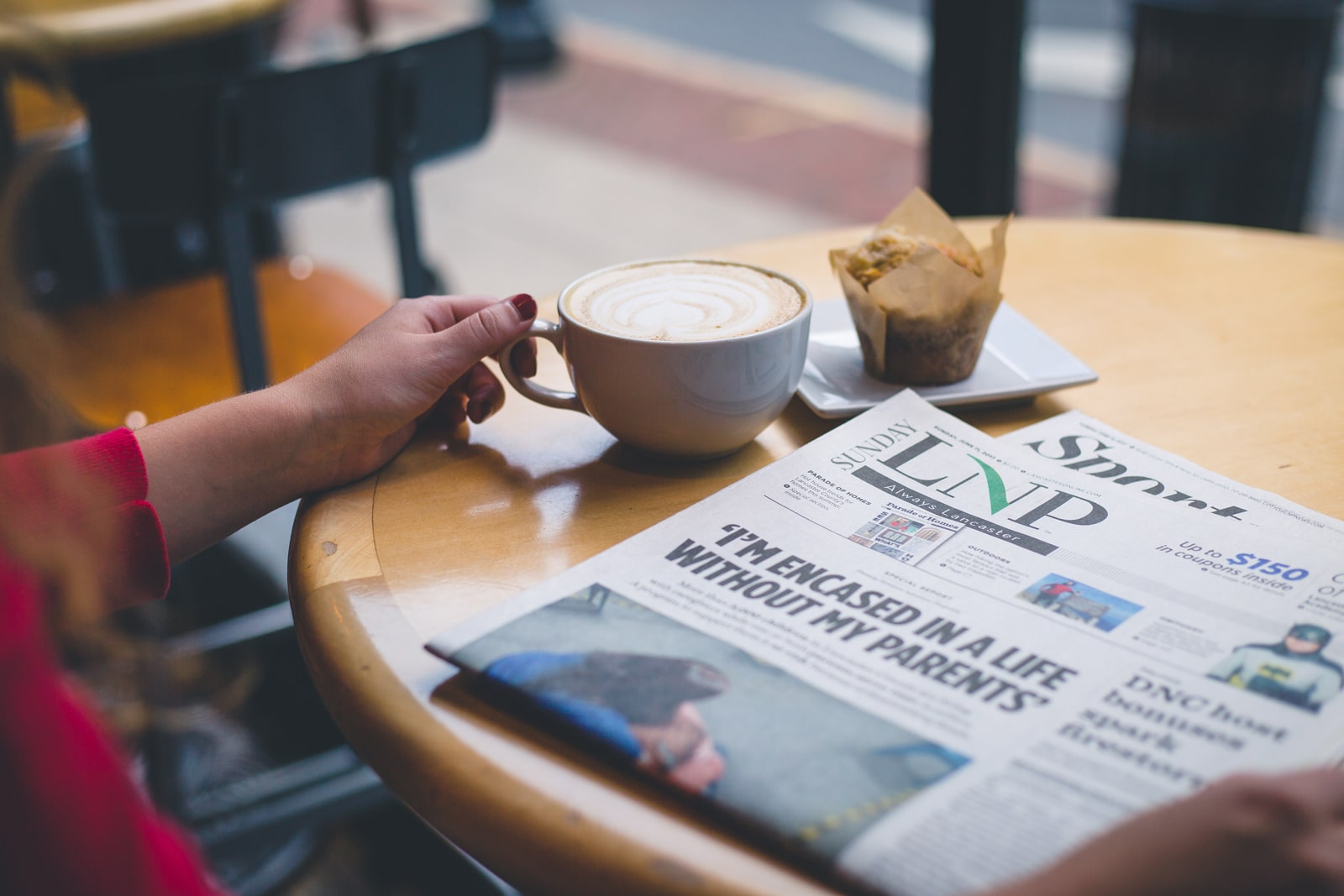 Woman reading LNP newspaper