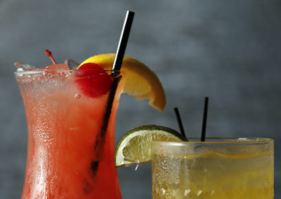 Close up of two cocktails and garnishes