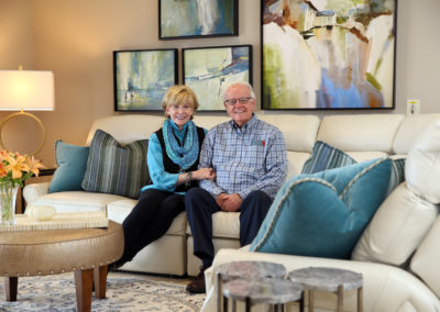 Elderly couple sitting on a couch in apartment